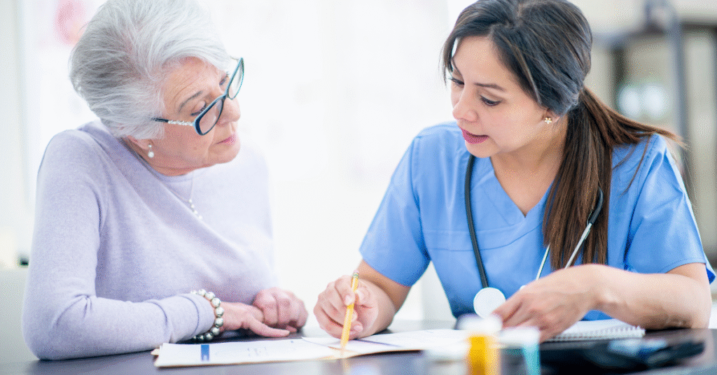 long-term care nurse talking with elderly patient about medication reconciliation.